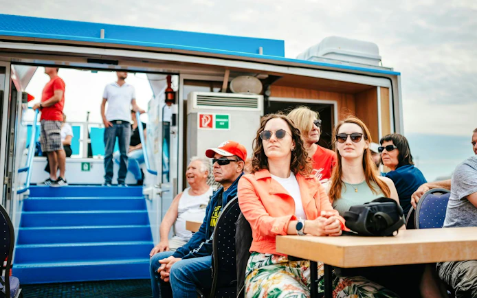 Guests seated on a boat during the 2-Hour XXL Port of Hamburg Cruise Tour.