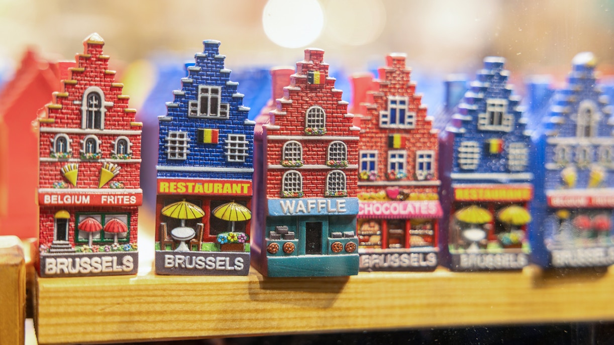 Brussels souvenir magnets featuring colorful miniature buildings with local themes.