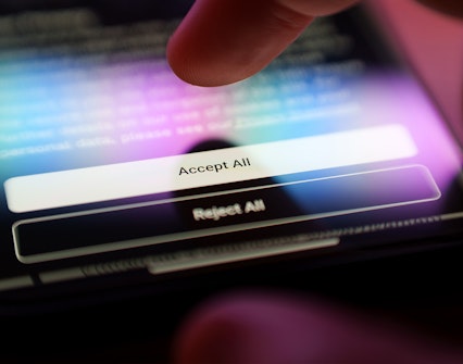 Accepting terms on a smartphone screen with a finger tapping "Accept All".
