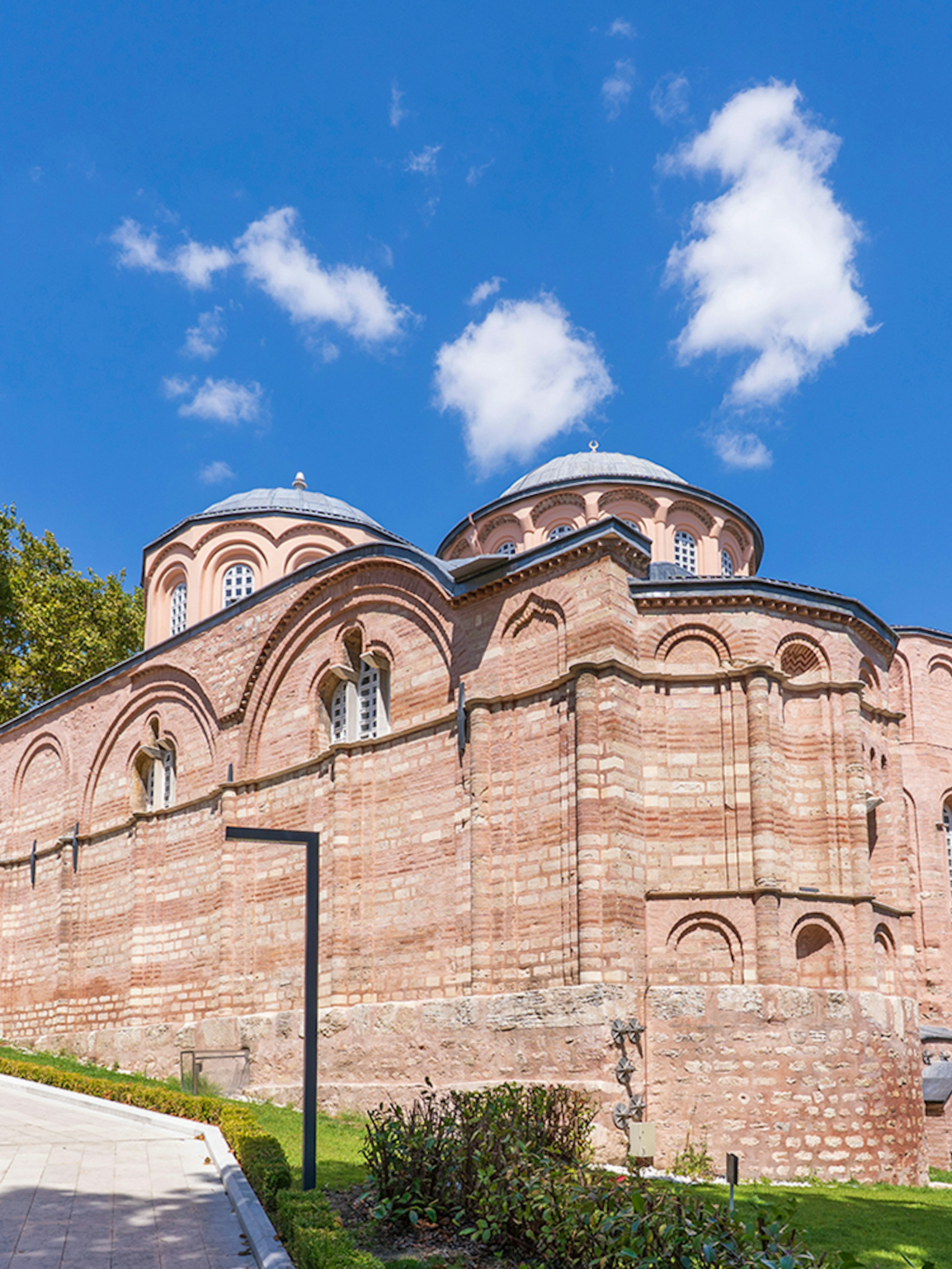 Kariye Mosque exterior with minaret and domes in Istanbul.
