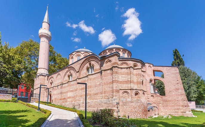 Kariye Mosque exterior with minaret and domes in Istanbul.