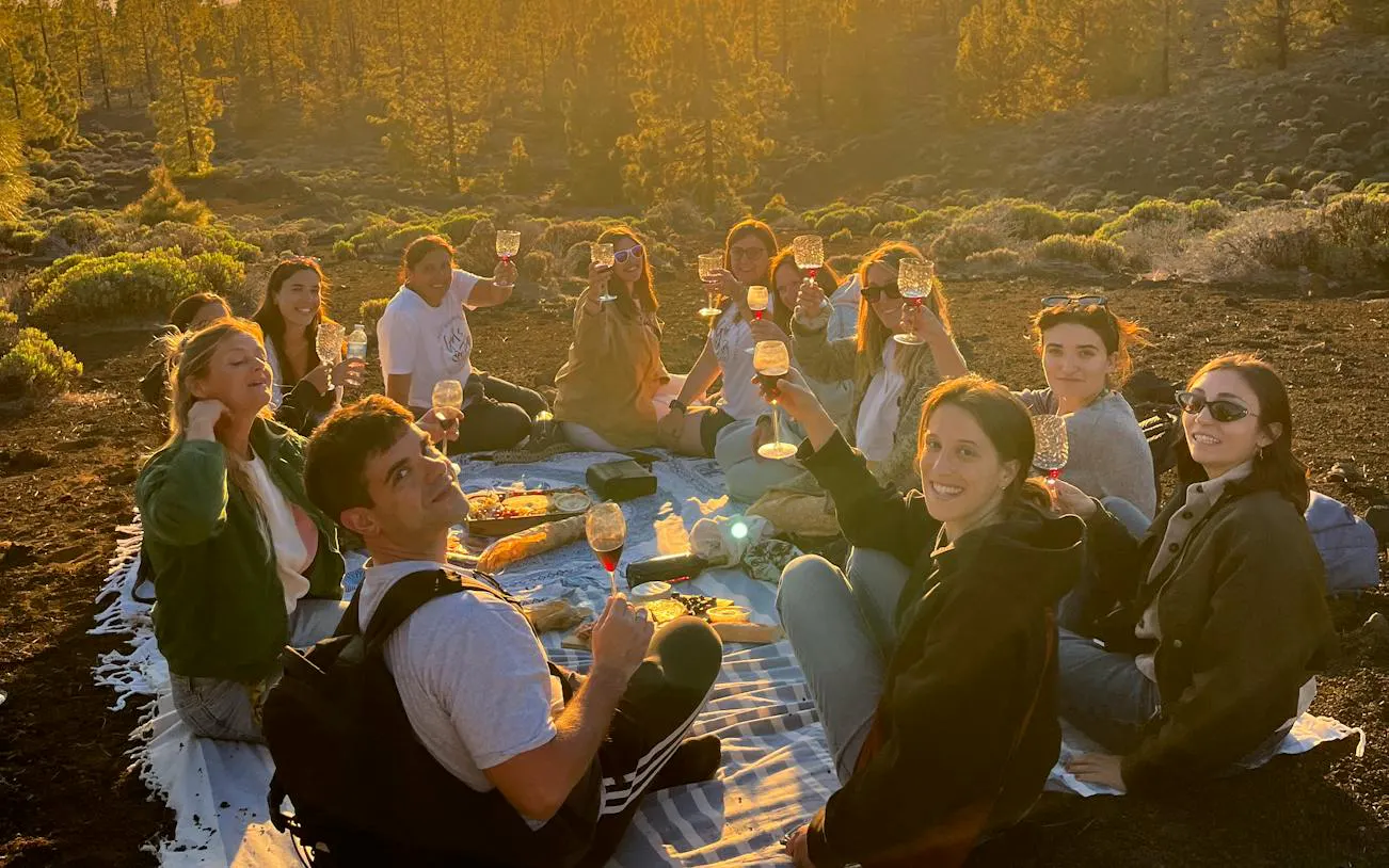 Group enjoying sunset picnic at Teide National Park, Tenerife, during stargazing tour.