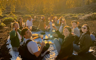 Group enjoying sunset picnic at Teide National Park, Tenerife, during stargazing tour.