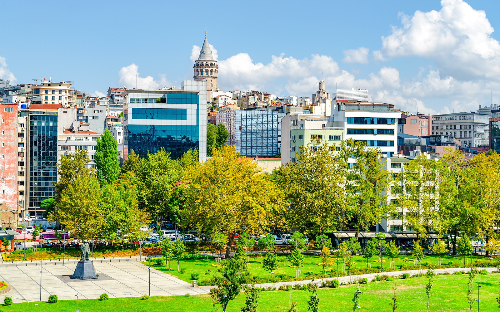 Istanbul skyline with Galata Tower and Karaköy waterfront green spaces.