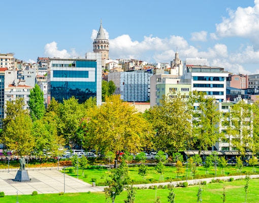 Istanbul skyline with Galata Tower and Karaköy waterfront green spaces.