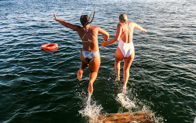Jumping into the sea during Algarve sightseeing cruise with Benagil Caves visit.