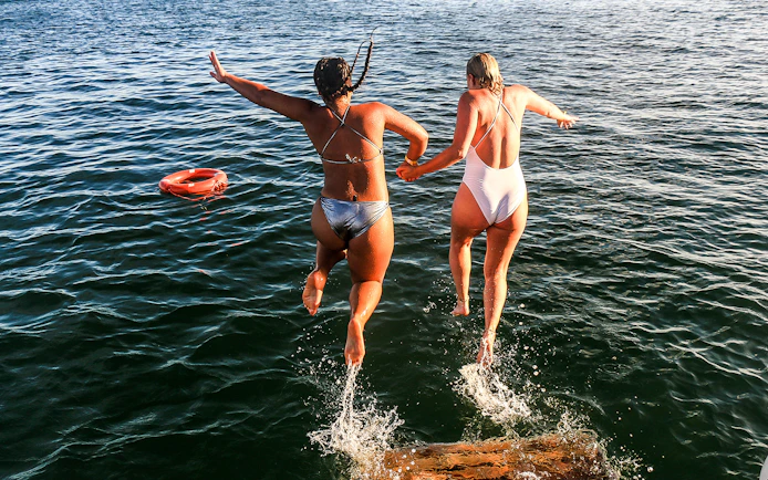 Jumping into the sea during Algarve sightseeing cruise with Benagil Caves visit.
