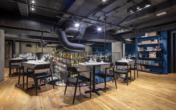 Dining area setup for Czech tapas cuisine tasting tour with tables and chairs.