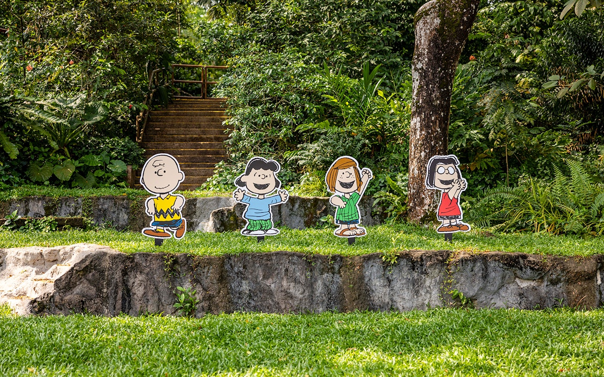 Snoopy and Beagle Scouts characters at Singapore Zoo garden setting.