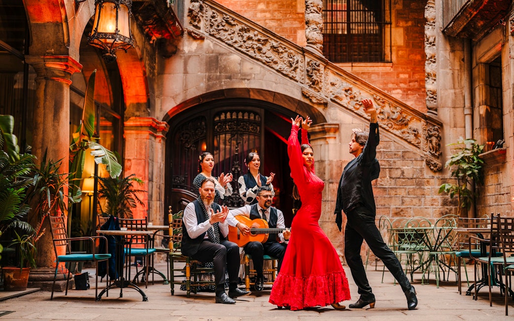 Flamenco dancers performing at Palau Dalmases courtyard in Barcelona.