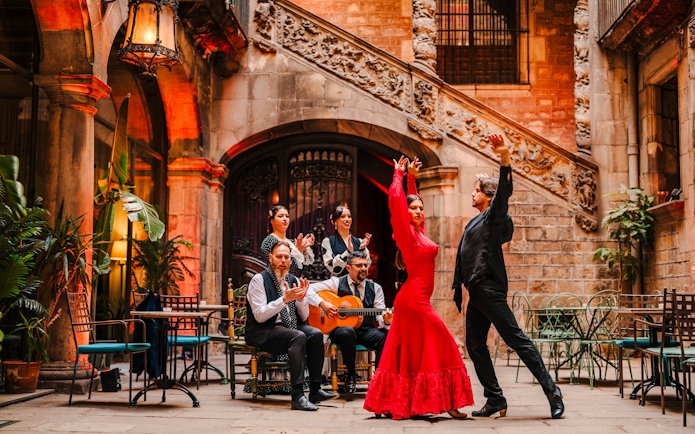 Flamenco dancers performing at Palau Dalmases courtyard in Barcelona.