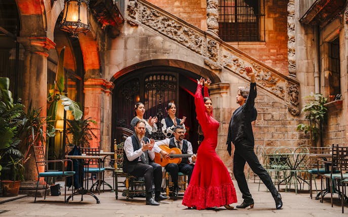 Flamenco dancers performing at Palau Dalmases courtyard in Barcelona.