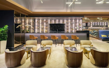 Sky Suite Airport Lounge with seating, bar, and elegant decor in Terminal 1 & 2.