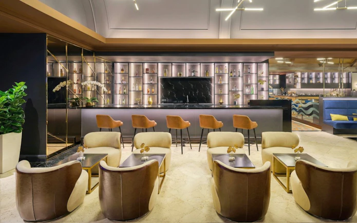 Sky Suite Airport Lounge with seating, bar, and elegant decor in Terminal 1 & 2.