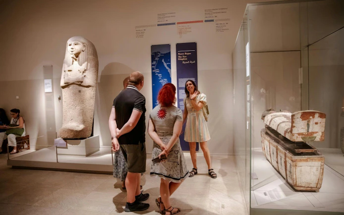 Tour group exploring ancient artifacts at the Egyptian Museum in Turin.