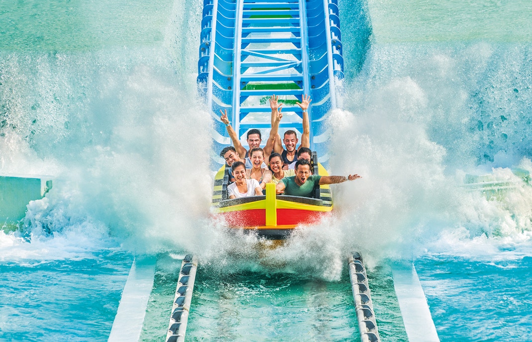 People enjoying a water ride at Desaru Waterpark, Malaysia.