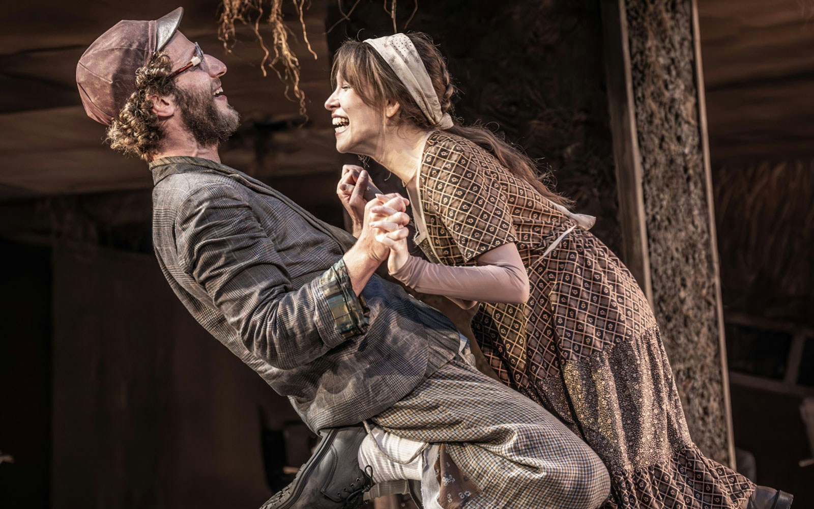 Actors performing a joyful scene in "Fiddler on the Roof" musical.
