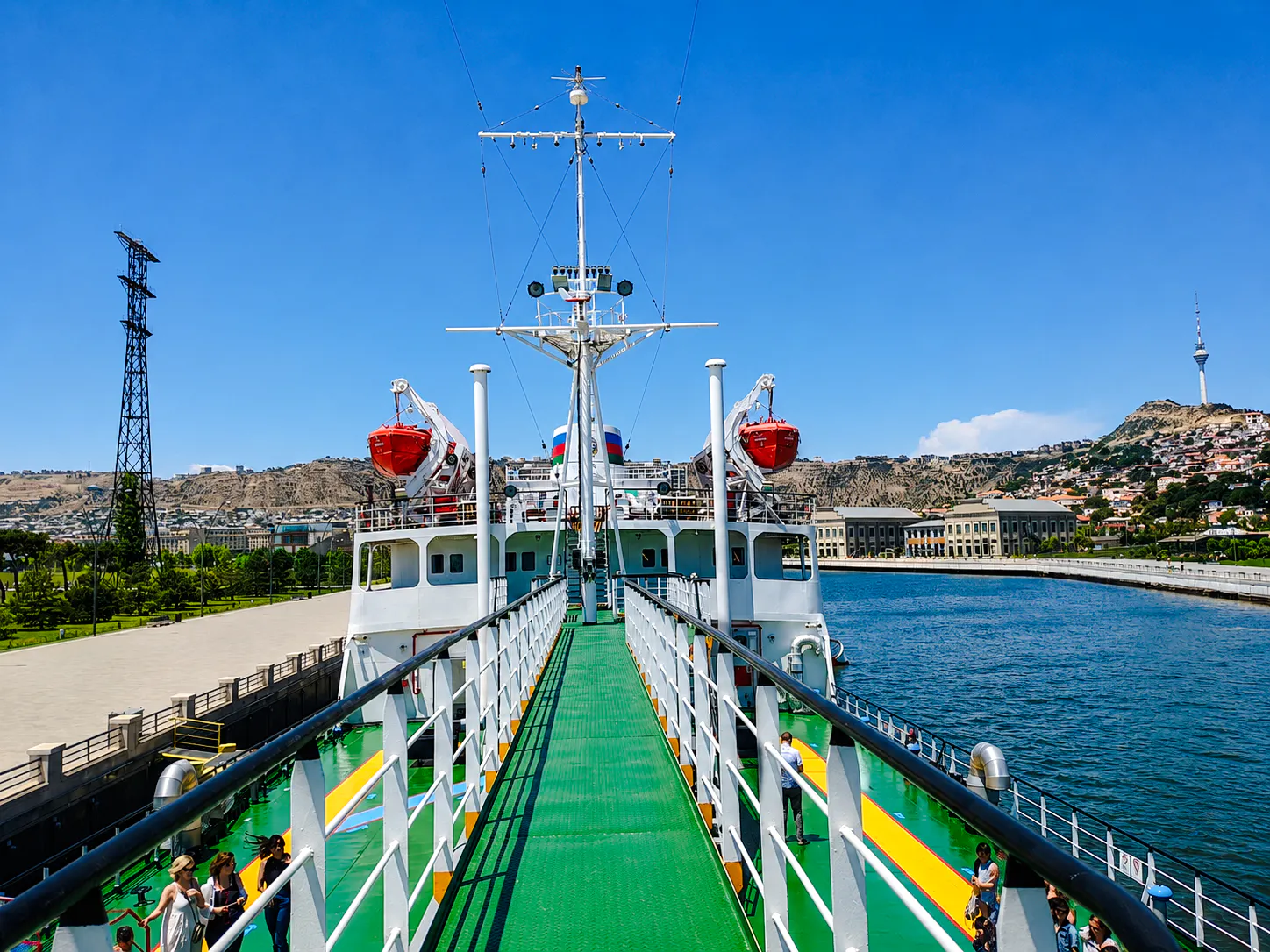 Deck view of the world's first tanker museum ship in Baku, with cityscape and Caspian Sea in the background.