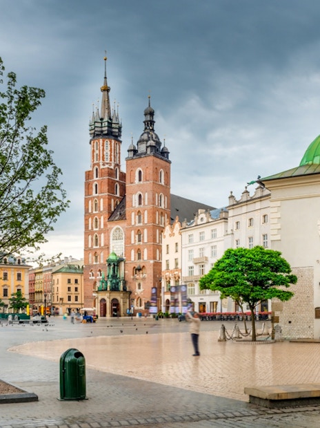 Saint Mary's Basilica in Krakow's Old Town square with surrounding historic buildings.