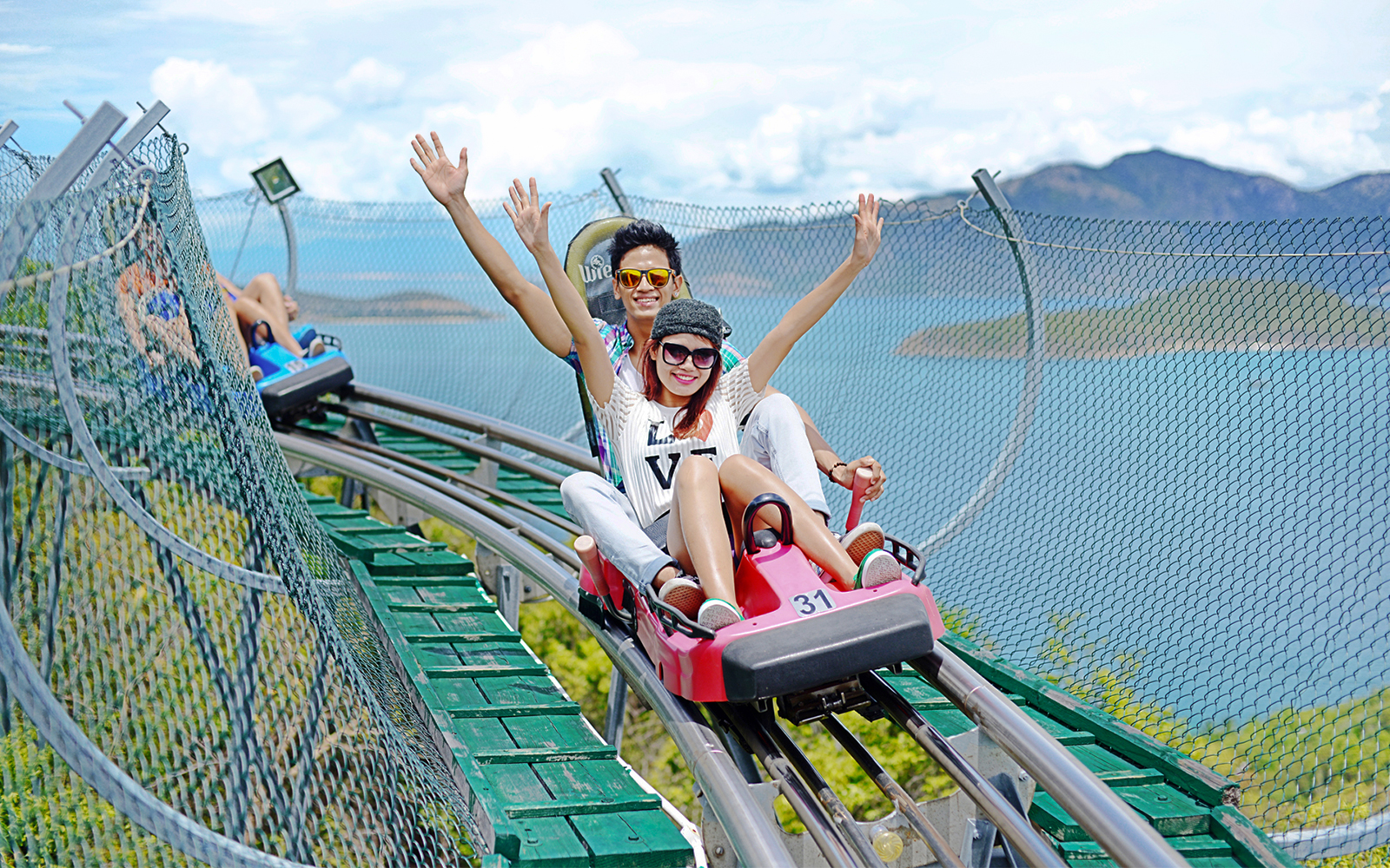 Friends enjoying Alpine Coaster ride at VinWonders Nha Trang Theme Park.