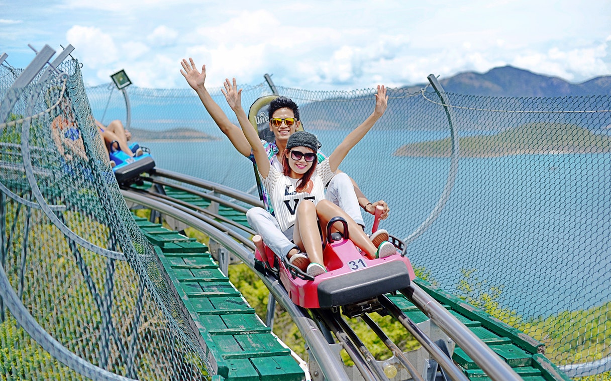 Friends enjoying Alpine Coaster ride at VinWonders Nha Trang Theme Park.