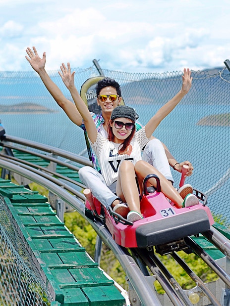Friends enjoying Alpine Coaster ride at VinWonders Nha Trang Theme Park.