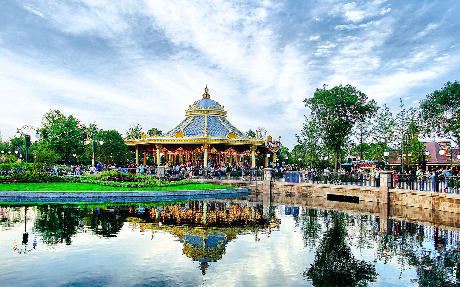 Carousel at Shanghai Disney with reflection in a pond.