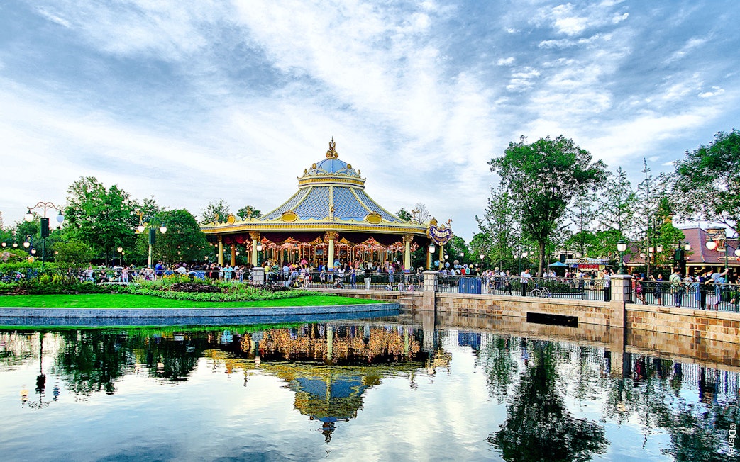 Carousel at Shanghai Disney with reflection in a pond.