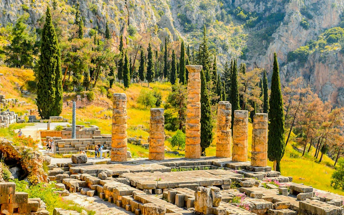 Temple of Apollo ruins at Delphi Archaeological Site with surrounding landscape, near Athens.