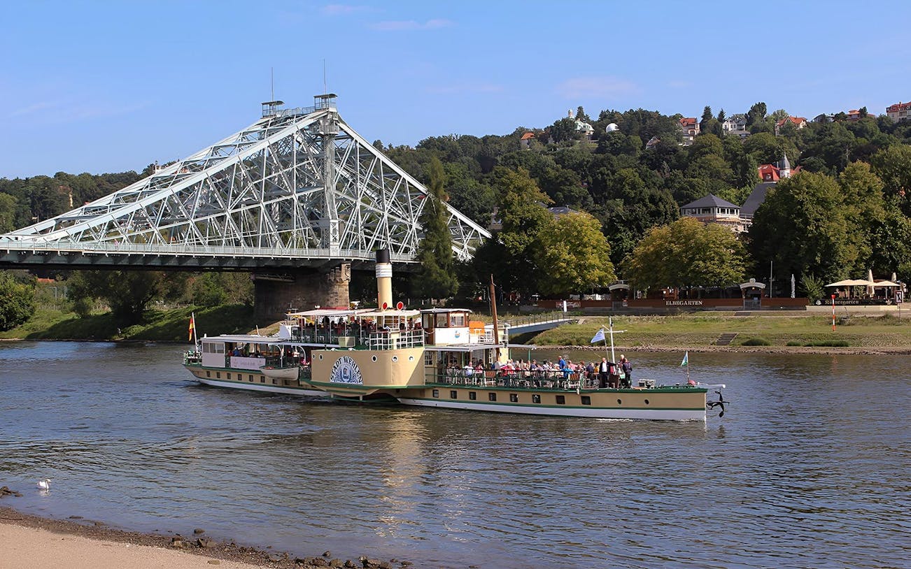 Ship cruising under the Blue Wonder bridge in Dresden during a guided tour.