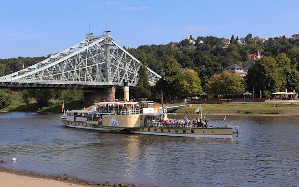 Dresden tour ship passing under Blue Wonder bridge on the Elbe River.