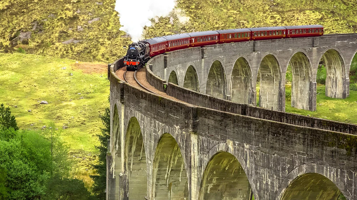 Jacobite Steam Train crossing Glenfinnan Viaduct in the Scottish Highlands.