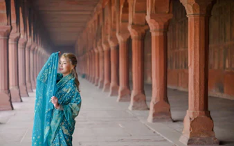 Person in traditional attire at Agra Fort corridor, Agra.