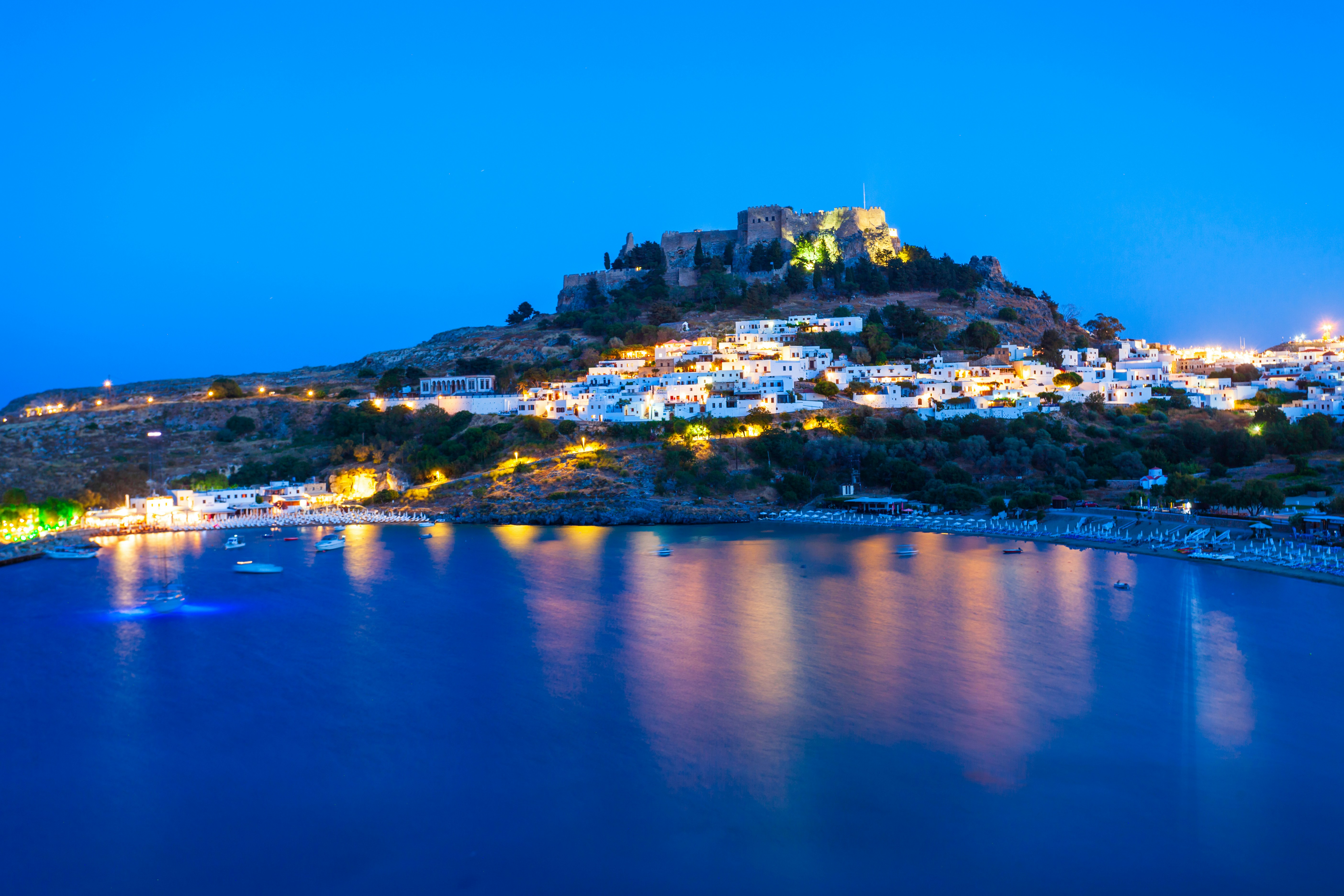 Rhodes Town skyline at sunset viewed from a cruise, Greece.