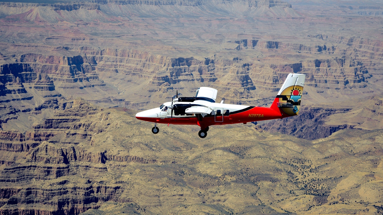 Grand Canyon aerial view with Hummer tour vehicles, part of 140-min Las Vegas to Grand Canyon National Park tour.