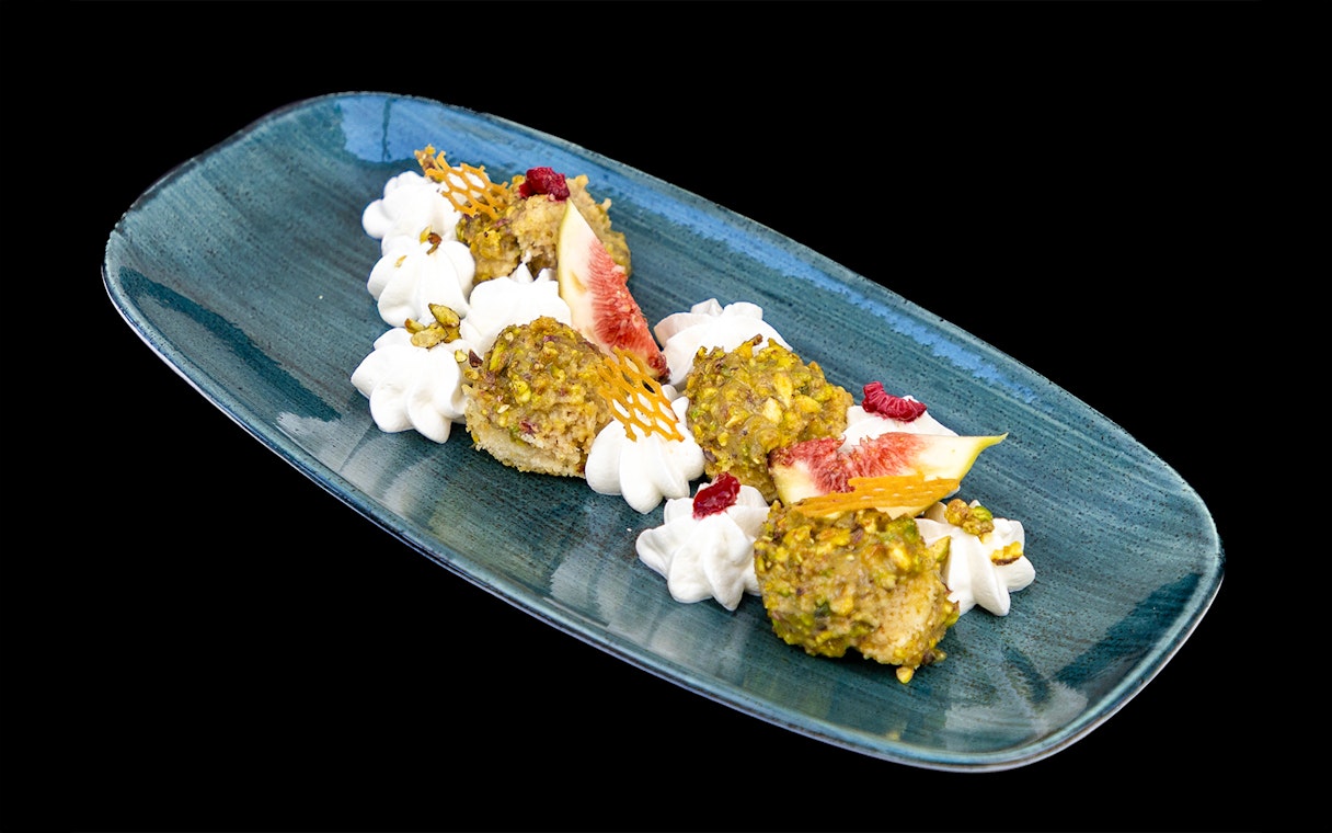 Pistachio-crusted dessert with figs and cream on Budapest Dinner Cruise.