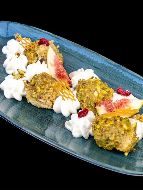 Pistachio-crusted dessert with figs and cream on Budapest Dinner Cruise.
