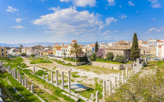 Roman Agora ruins with columns and ancient buildings in Athens, Greece.