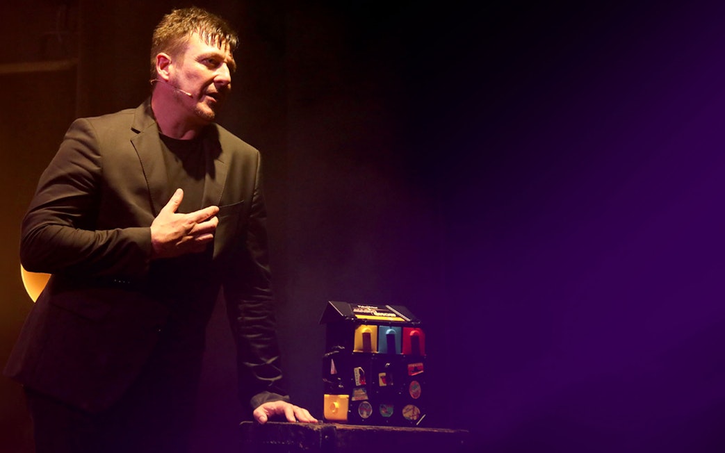 Performer in Jamie Allan's Amaze theatre act with props on stage.