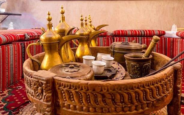 Traditional Arabic coffee pots and cultural artifacts inside Dubai Coffee Museum.