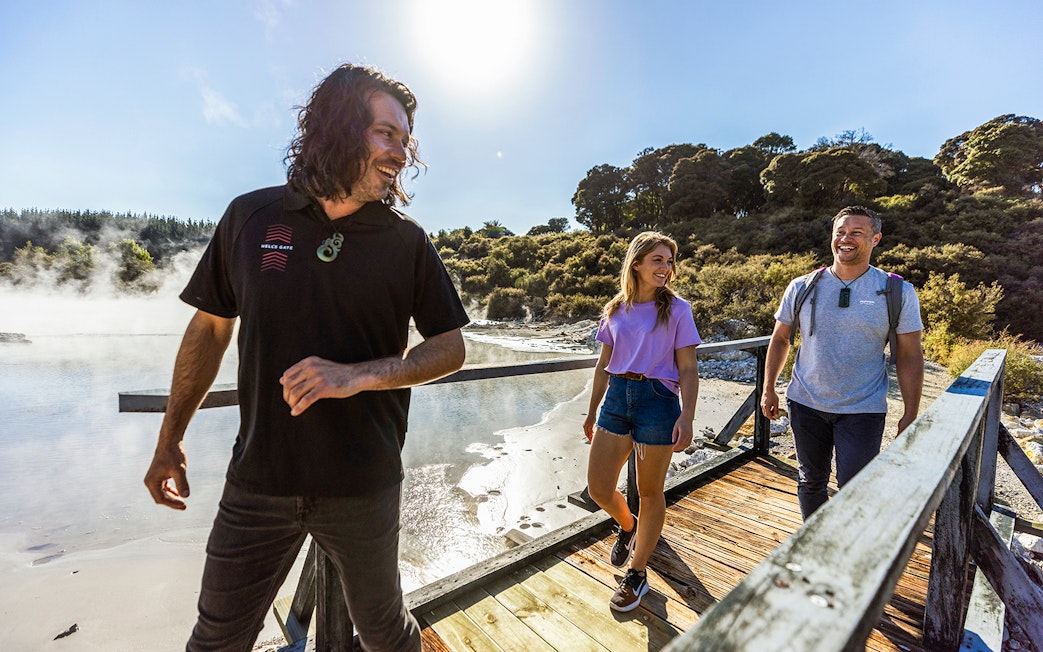 Tourists enjoying a guided walk at Hells Gate Geothermal Park, New Zealand.
