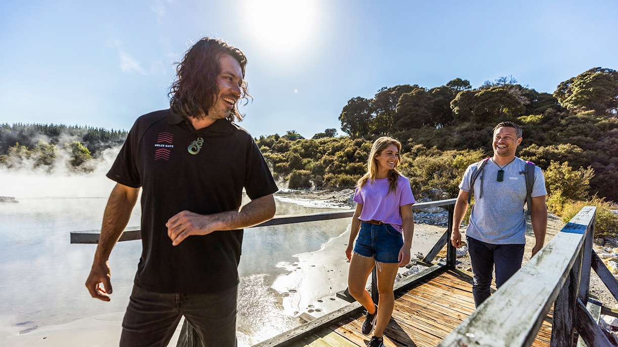 Tourists enjoying a guided walk at Hells Gate Geothermal Park, New Zealand.