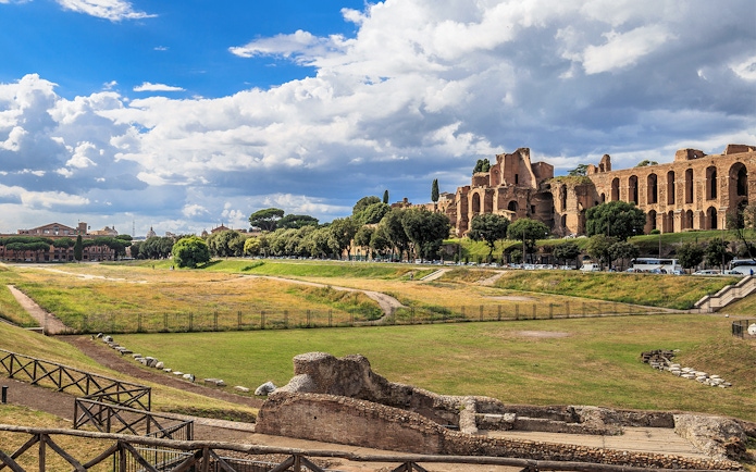 Circus Maximus ruins with surrounding greenery in Rome, Italy.