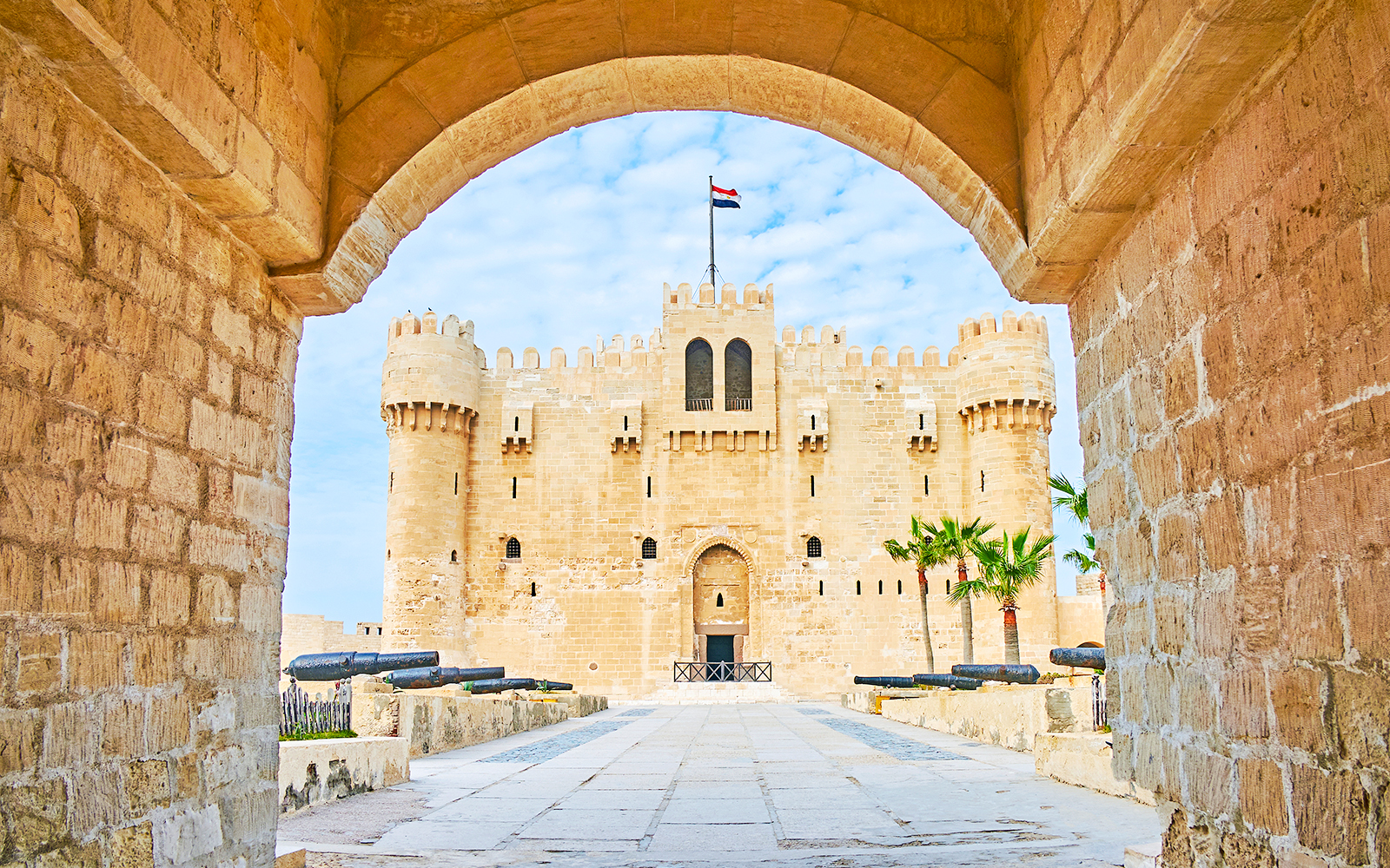 Citadel of Qaitbay in Alexandria, Egypt, viewed through stone archway.