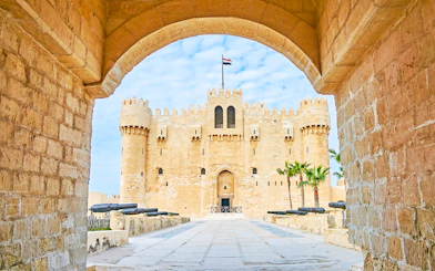 Citadel of Qaitbay in Alexandria, Egypt, viewed through stone archway.