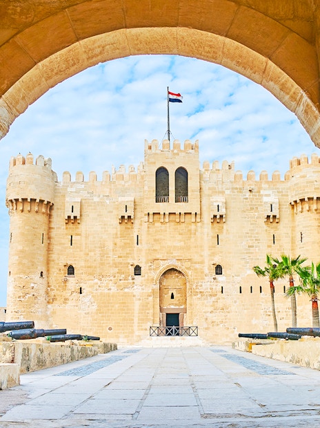 Citadel of Qaitbay in Alexandria, Egypt, viewed through stone archway.