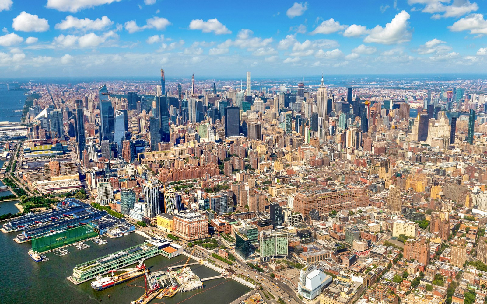 Aerial view of Manhattan skyline, New York City, featuring skyscrapers and Hudson River.