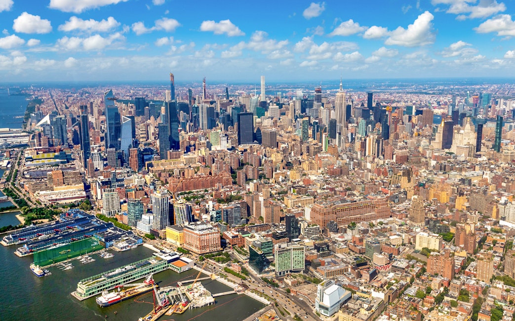Aerial view of Manhattan skyline, New York City, featuring skyscrapers and Hudson River.