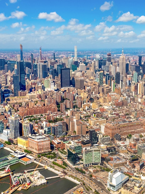 Aerial view of Manhattan skyline, New York City, featuring skyscrapers and Hudson River.