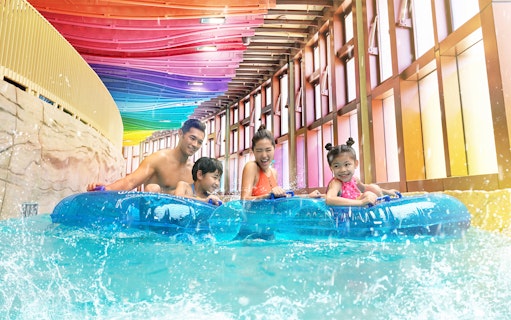 Family enjoying a water ride at Water World Ocean Park Hong Kong.